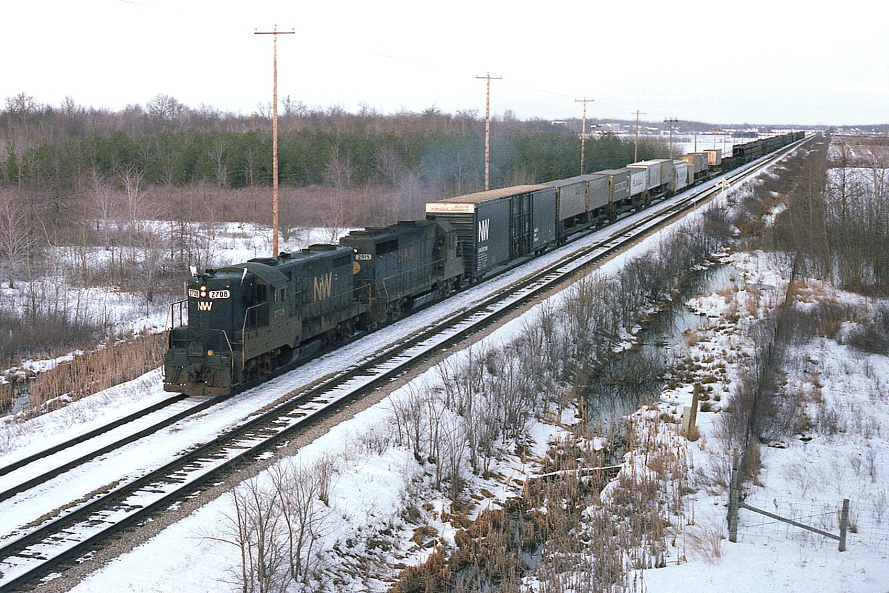 Nice to see Extra flags flying, as N&W 2708, 2915 heads westbound, as seen from the Wilhelm Road overpass. Hard to believe it has been 40 years. That is "CN Robbins" in the distance.