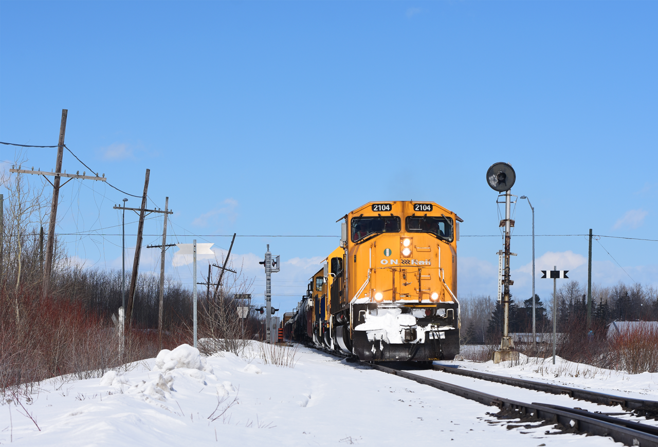 Passing by one of many defunct GRS searchlight masts of the Temagami Sub ONR 2104 with train 214 is Southbound towards North Bay.