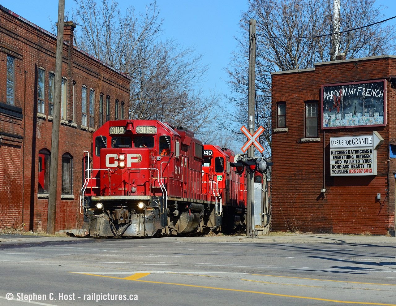 After spending hours switching in North Hamilton the Kinnear yard job TH31 is seen passing between the buildings at Main and Gage on the former TH&B Belt Line. It has been a few years since I've shot here, the last time the motive power was a  trio of GP9's  and this time a trio of GP38-2's making for a nice contrast.