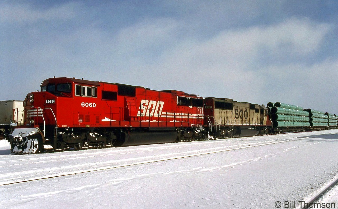 SOO SD60M 6060 and SD60 6013 handle a freight through Smiths Falls in February 1992. 6060 was one of five safety-cab equipped SD60M units ordered by SOO and built by GMD in 1989, after purchasing 58 of the standard cab version. They were later rebuilt by CP as 6200's and still operate today.