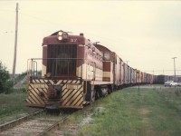 TH&B locomotive #57 is on boxcar switching duties at Maple Leaf Mills.  The once so common boxcars that filled the Port Colborne railyards would disappear completely within a few years.  The switching is holding up traffic at the King Street crossing. TH&B Van 83 is in the mix.  