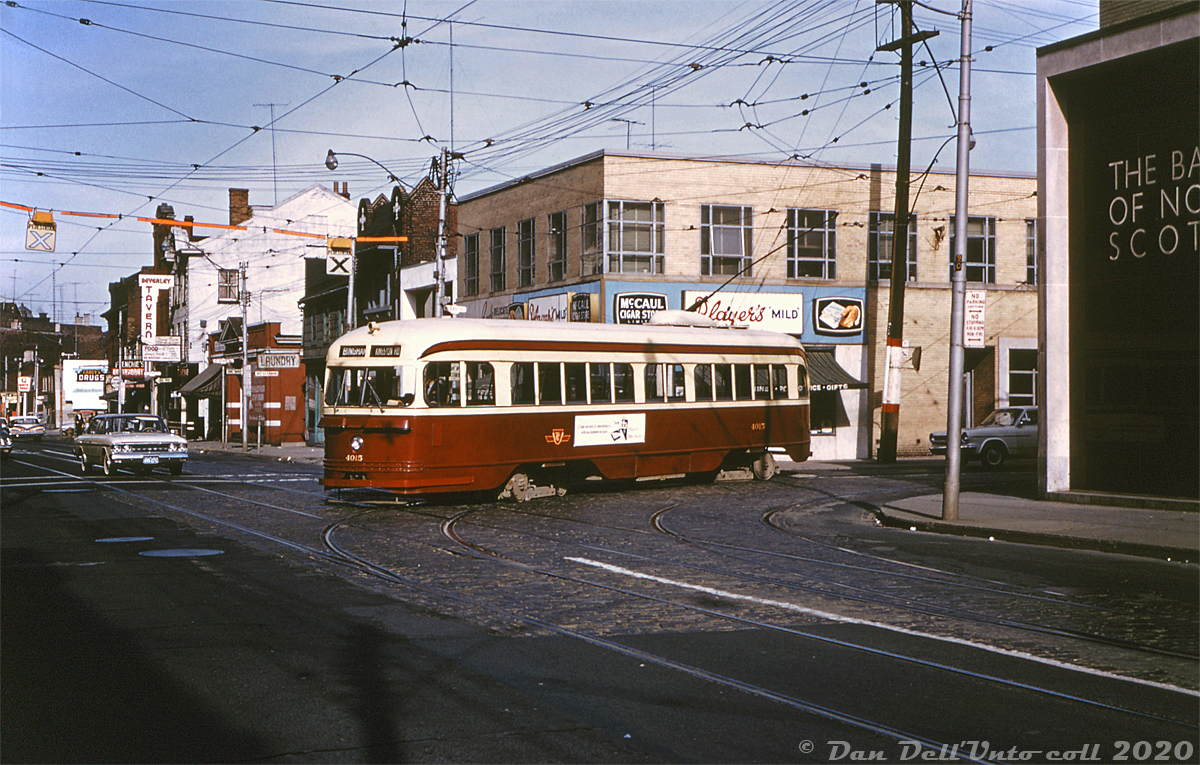 TTC PCC 4015 (an early A1-class car built in 1938) operating on the Kingston Road route, is seen coming off McCaul Street onto traffic on Queen Street, where it will head back east bound for Kingston Road and Bingham Loop in the east end.

The McCaul branch of the Kingston Road cars usually ran to McCaul Street and up to McCaul Loop, their end terminus, where they turned before heading back down to Queen and then eastward (mixed with regular Queen cars) for Kingston Road. This operation continued (with a few changes over the years) and became the 502 "Downtowner" streetcar which still runs on Queen St. to McCaul Loop today.

John F. Bromley photo, Dan Dell'Unto collection slide (duplicate).