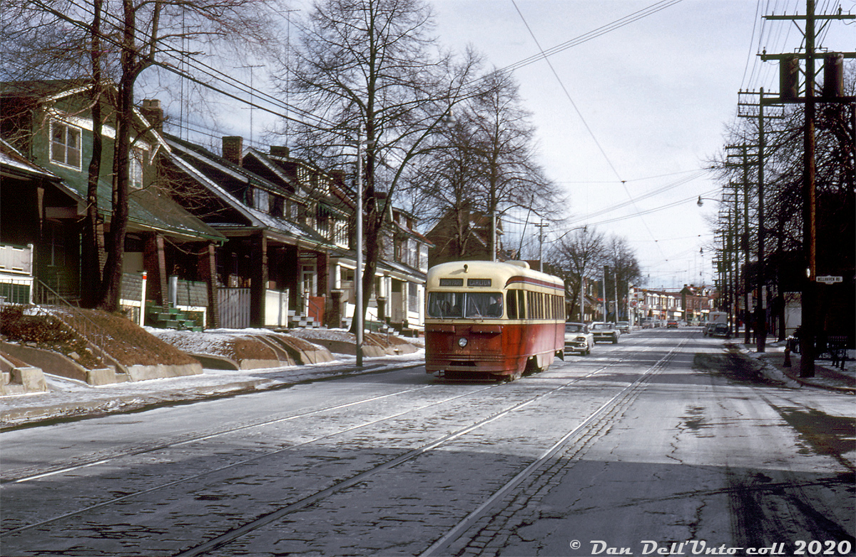 In this cold winter morning scene, TTC PCC 4098 (an A1 class car built new by CC&F in 1938) heads westbound on the Carlton route passing through east end Toronto (the Upper Beaches area), travelling westbound on Gerrard Street East passing Bellhaven Road to the west of Woodbine.

Four years earlier, car 4098 was involved in an incident with sister car 4052 when it rear-ended 4098 at Queen & Alton, damaging both cars and putting them out of service. As per TTC's Coupler employee magazine, 4052's front end was damaged beyond repair, so its intact rear end was cut off by Hillcrest Shops and welded onto the rear of 4098 to replace its wrecked end, and 4098 was put back into service. 4052 and was stripped of usable parts and scrapped. 4098 lasted a few more years until the Bloor-Danforth subway opened and rendered a lot of the TTC's older PCC streetcars surplus.

John F. Bromley photo, Dan Dell'Unto collection slide.
