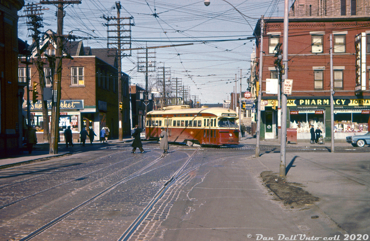 People go about their day on a Winter afternoon as TTC PCC 4399 (the last of the A6-class of PCC's, 4300-4399, built by CC&F in 1947-48) sneaks through the intersection on a yellow, turning eastbound off McCaul Street onto Dundas Street West while operating on the Harbord route on the trip from St. Clarens Loop (Davenport near Lansdowne) to Lipton Loop in the city's east end (Pape near Danforth). The zig-zagging Harbord streetcar route would be nixed in a few years when the Bloor-Danforth subway opened in February 1966, but 4399 would go on to serve nearly three more decades prowling Toronto streets, becoming the last A6 car in service when it was retired in 1990.McCaul, an often overlooked street, still has streetcar tracks that connect College-Dundas-Queen, as well as McCaul Loop (north of Queen) used for short turning 502 Downtowner (former Kingston Road) streetcars.John Freyseng photo, Dan Dell'Unto collection (this one was a badly cyan-shifted EATONS processed Ektachrome(?) slide, with quite a bit of colour adjustment and editing performed).