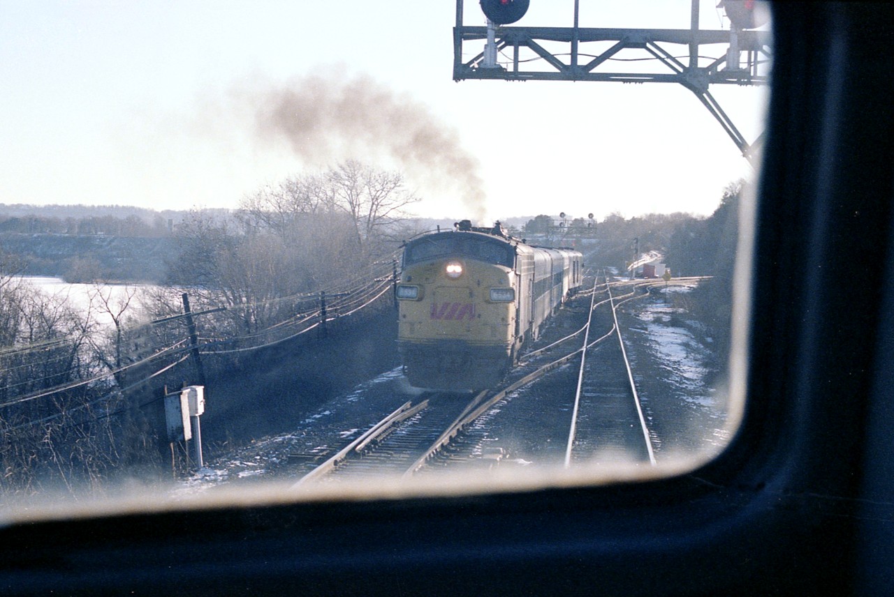 A grubby image could have been a lot better with a clean windshield.:o) But, you take what you can get. Upon being invited aboard VIA 6768 (#73) I had to take advantage of the opportunity to get a scene that was rarely available to me.
VIA 6534 (#72)has just come off the hill and in a moment I would detrain and #73 would be on the move. I cannot recall the situation now but I suppose at this particular time the south track must have been the only one in service.
Forty years ago last month. Time flies.