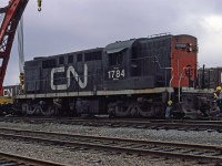 CN people are working with crane CN 50000 to get MLW RSC-14 CN 1784 back on track after a derailment in Halifax.<br><br>
The RSC-14's were RS-18's re-trucked by CN to spread their weight across six axles, for branch lines with light rail in the Maritime provinces. <br>
The A1A trucks were taken from retired RSC-13's and RSC-24's which previously served that assignment. <br>
RSC-14's were derated from RS18 original 1800 HP to 1400 HP, probably the safe limit for the A1A traction motors.<br><br>
Location within Halifax is unstated, mapped to vicinity of Fairview. 