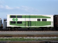 This unusual conversion of a 40 foot boxcar was seen in GO Transit's Willowbrook Yard on several occasions in the early 1990's. By then it could have been retired, like GO's stored APCU's, APU's and GP40M-2's.<br>
It is painted to resemble one end of GO Transit 2+level coach, with windows, etc. <br><br>
IIRC someone told me it had been used for teaching conductors GO train door control operation.<br> 
If so, one feature it lacks is an openable window in the conductor's original upper-level location.