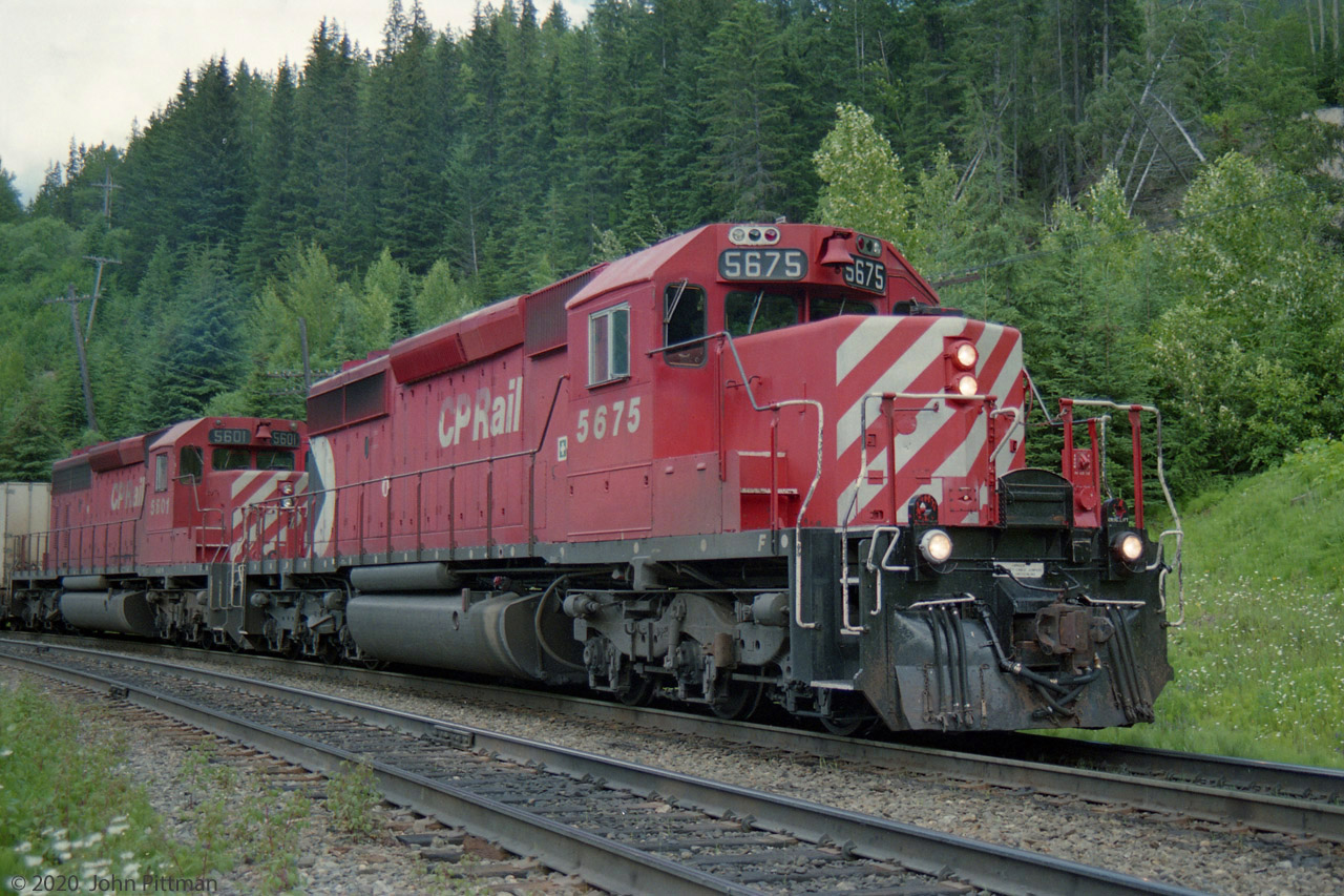 SD40-2 units CP 5675 and CP 5601 were photographed alongside Partridge passing siding on the CP Laggan sub.
This is the high ground near Kicking Horse Pass, just before the main descent of CP's Big Hill though the Spiral tunnels to division point Field BC. The railway is already on a descending grade westward.
Less than a minute after this picture, the brakes were released and this train resumed its westward journey.
On occasion Partridge serves as crew change point instead of Field BC, for crews approaching maximum hours of service.
25 and a half years after my picture, a crew change here ended in tragedy. On 4 February 2019 westbound CP  301-349 rolled away from Partridge just after the relief crew boarded. For details see TSB R19C0015:  https://www.tsb.gc.ca/eng/enquetes-investigations/rail/2019/r19c0015/r19c0015.html