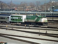 Retired GO Transit equipment, including GP40-2w GOT 706 and unique 40' boxcar CN 561747 (done up like a GO multilevel coach), seen on a storage siding in Willowbrook Yard. Early spring of 1991 (or 1990).<br>
All but one of GO Transit's GP40-2W's were acquired by CN in 1991, GOT 706 becoming CN 9673.<br>
On CN the ex-GO locomotives retained green & white paint for a while, minus the white GO plates from the handrails.<br><br>
Beyond the fence are CN Oakville sub main lines, then VIA yard tracks with LRC coaches (in service), and quite a fleet of VIA Budd RDC's behind them (many stored/retired pending disposal).

