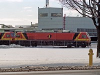 St Patrick is the patron saint of Ireland, and March 17 is his day - prompting this submission.<br><br>
New JT42HCW locomotives 217 and 218 for Irish Rail (Iarnród Éireann) are pictured outside the GM Diesel Division Plant in London ON. As of 2019 this class of locomotives was the newest and most powerful in Ireland.
<br>Note the taller green-primer domestic units behind this export pair.<br><br>
The railways of Ireland have a track gauge of 5' 3", wider than international standard gauge which is 4' 8-1/2". Dissatisfied with previous diesel locomotives sourced from England, Irish Rail ordered their "201 class" of new locomotives from EMD / GM Diesel Division. They were built in 1994 and early 1995 with unit numbers from 201-234, including 2 built for Northern Ireland Railways.<br><br>
JT42HCW locomotives are powered by an EMD V 12-710G3B diesel engine of 3200 gross HP (2970 HP for traction). These locomotives had the capability of using the prime mover to provide Head End Power for passenger coaches, but problems experienced with this system have ended its use. Instead a 4000 series "Driving Van Trailer" is normally placed at the other end of intercity passenger trains, equipped with a diesel generator set for coach lighting and HVAC, and a control cab for push-pull operation.<br><br>
In recent years the majority of Irish intercity passenger trains are operated by diesel multiple units, an exception being Cork-Dublin services which are generally locomotive powered. I saw several 201-class locomotives on passenger trains at Cork station in 2015, in a different colour scheme. JT42HCW locomotives also power freight trains in Ireland.