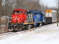 CN GMD1u 1444 (the highest numbered in the series) and GMTX 2695 bring CN train L540 by the frozen landscape along the Huron Park Spur near Queen Street in Kitchener, Ontario. The train is returning with cars lifted from the Canadian Pacific interchange in Kitchener.
