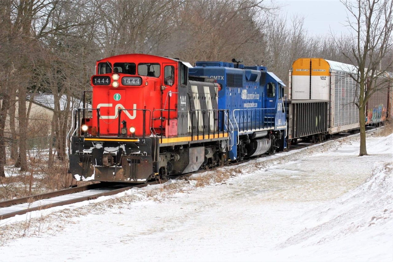 CN GMD1u 1444 (the highest numbered in the series) and GMTX 2695 bring CN train L540 by the frozen landscape along the Huron Park Spur near Queen Street in Kitchener, Ontario. The train is returning with cars lifted from the Canadian Pacific interchange in Kitchener.