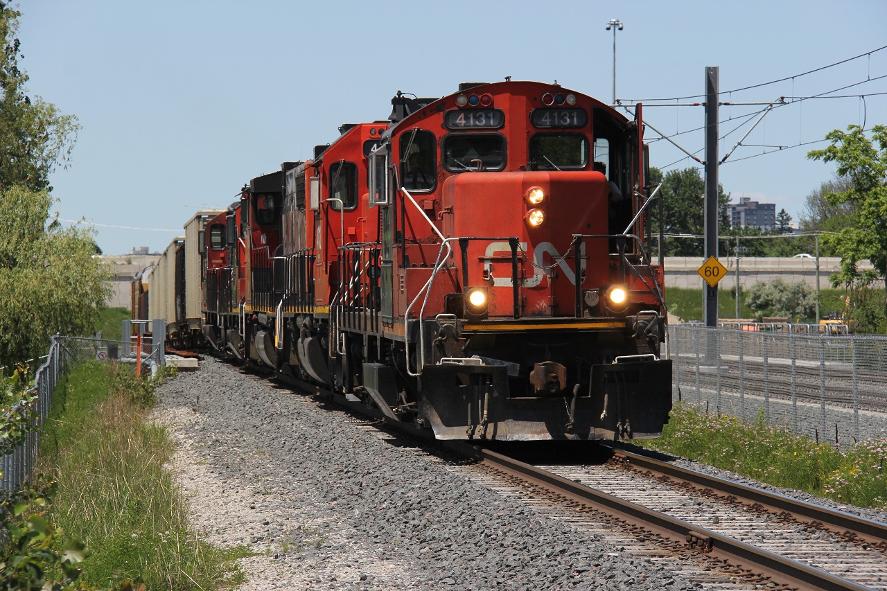 CN 4131 leads four other CN geeps of various varieties southbound on the Huron Park Spur on the approach to Hayward Ave. and the CN/CP Interchange. At right is the LRT line which was fully operational the day before. I was at this location quite often last summer, hoping for an LRT/freight meet - got close, but not close enough! It also helped that I lived a couple kilometres away.
