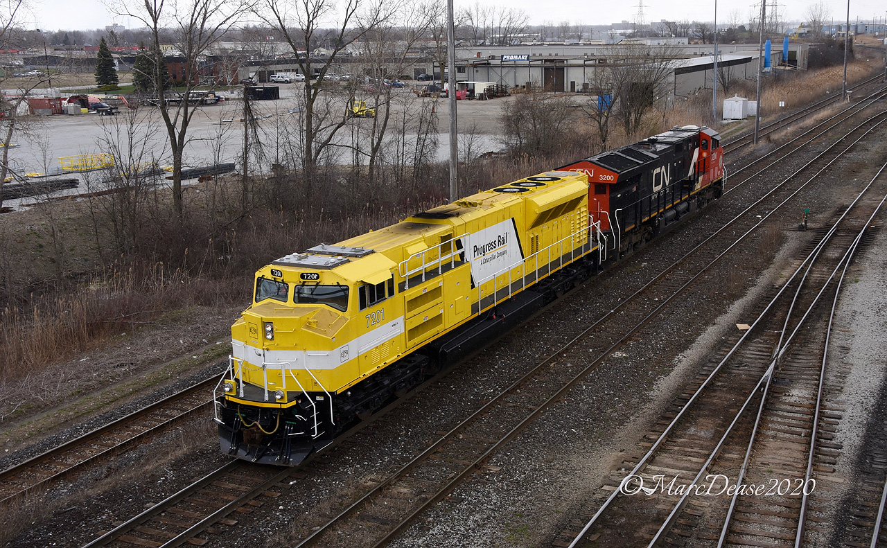 A strange turn of events today in Sarnia gave me the opportunity to catch one these EMD SD70ACe T4 Demonstrators leading although technically it is the trailing unit. X149 was held at Camlachie Sideroad because its power (IC 2458 and CN 2507) were not PTC equipped so they were not allowed to lead into the US. X149 came in light power and was swapped with what I believe was 482's power which is the EMDX 7201 Demo and CN 3200. So far these Demonstrator units have not led that I know of and today was no exception as this power had to wyed before being taken back out to lead X149 with the CN 3200 leading. Here they pass west bound in Sarnia at the Indian Road overpass. Despite the dreary conditions these units sure stick out.