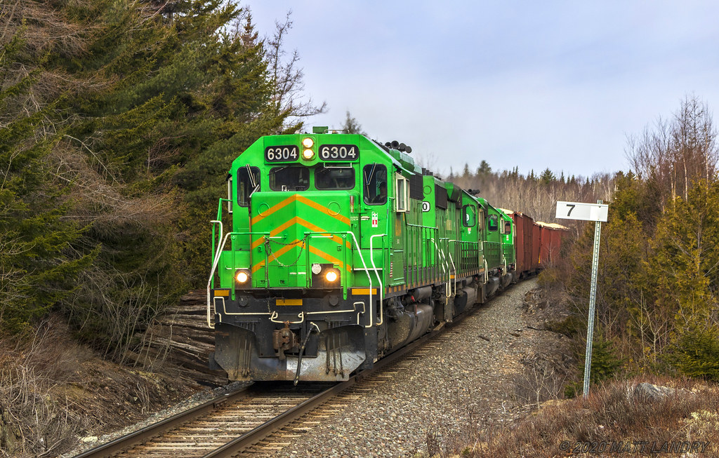 NBSR 6304 is passing the milepost at mile 7, getting handy to it's final destination of Saint John, New Brunswick. Mile 7 is Ketepec, a few miles to the north of Saint John.