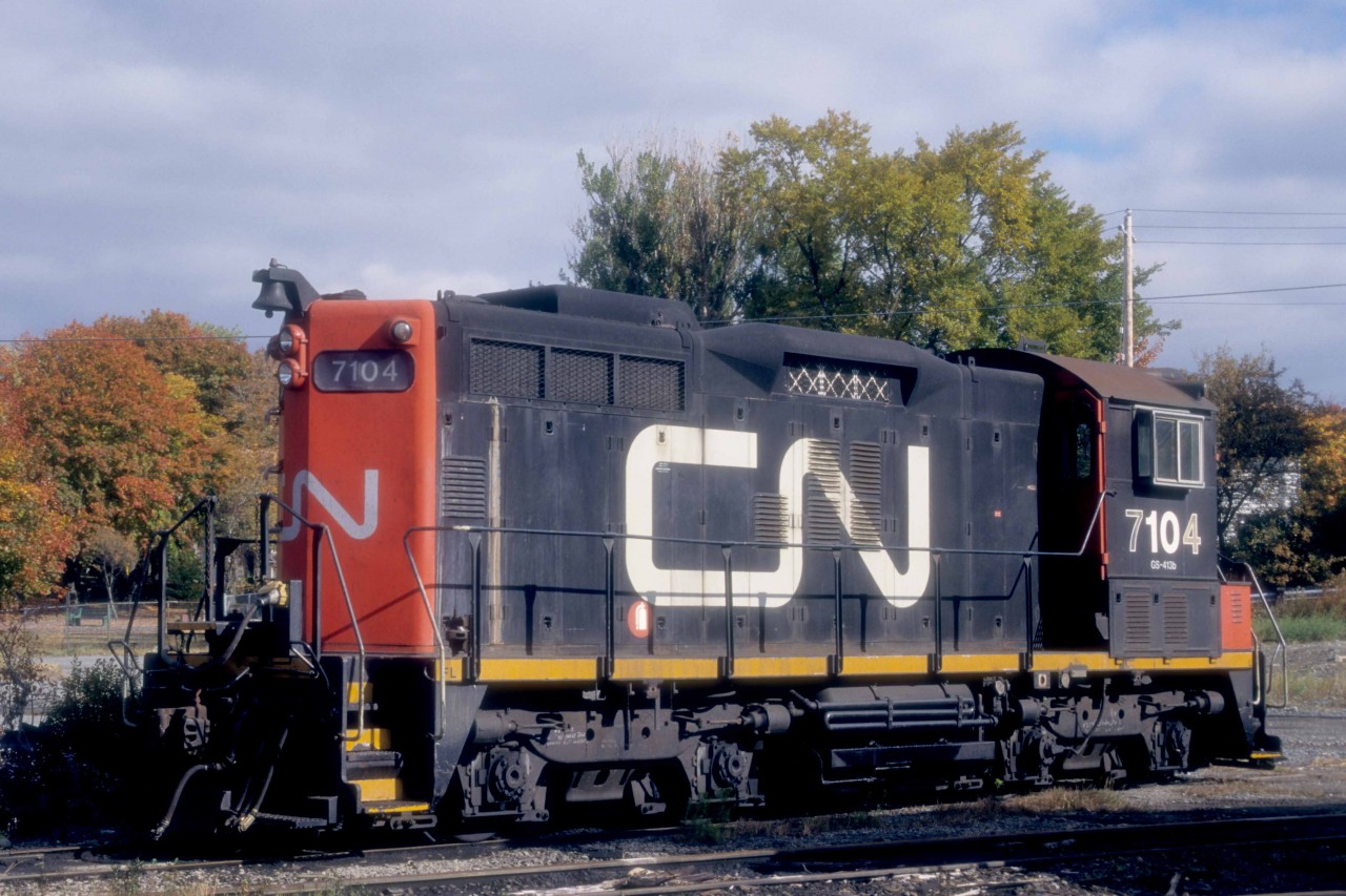 For a brief period in the late 1990s, Sweeps found work in Halifax, Nova Scotia, often in the mu company of SW1200RS units.  The odd couples worked the container piers, transfers and general switching at Rockingham Yard and downtown, at the Ocean Terminals.  

At 3.30 p.m. on Sunday, October 26, 1997, CN 7104 rests on the radial tracks at the Fairview Roundhouse.   

CN assembled the 7104 from major components of SW1200RS 1248, GMDL 11-1956 #A1020, the first of 21 units in class GR-12h.  It was retired in 1986, rebuilt at Point St. Charles and released as 7104 on Friday, May 1, 1987, with class GS-412b.  It was retired on Friday, February 29, 2000, and joined the Canac / Savage lease fleet, where it remains active.