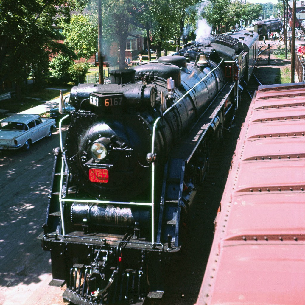 Northern-Type #6167 was built in 1940 and served as Canadian National’s steam ambassador from 1960 to 1964.  Photographer Del Rosamond didn’t date this large format slide but did record that it was captured in Lindsay, Ontario.  Internet research shows two UCRS excursions to Lindsay – one on 07/09/61 and the other on 06/20/64.  I’ve guessed the date of this image to be the latter.  Perhaps the parked automobiles might provide a hint?


Digital scanning and image restoration courtesy of Mr. Raymond Farand.