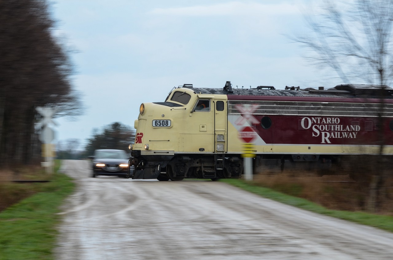 OSR’s Tilsonburg Job is seen blasting through Walker Road in the fields of Southern Ontario after lifting one tank car from IGPC Ethanol in Aylmer. Hard to believe this is it. This is the last (OSR) run on CN’s Cayuga Sub that’s seen many Wabash/N&W/NS run through trains in it’s time prior to the early 90’s. OSR’s plans to seize operations on the line between St Thomas and Tilsonburg really looked like reality today as they cleared every single tank car from Tilsonburg Yard on it’s return trip to St Thomas. It was great shooting it and it will truly be interesting to know what the future of the former “Air Line” has to offer. As a note, the motion blurred Mazda in the shot is RP contributes Mike Molnar and Alex Sanders who clearly lost the race to the intersection against 6508.