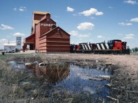 GMD1 1603 and two sisters are working the elevator at Riceton Saskatchewan on a beautiful spring day.
The train is working its way south on the Lewvan Sub running  south-east from Regina.  Sadly on this same day, the elevator at the Subdivisions namesake town will succumb to the wrecking ball. A few years later, the elevators, the rails and a load of prairie history will all have vanished.