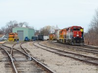 The conductor on 581 opens the door for a quick stretch departing Goderich as they prepare for the slow, jointed rail journey back to Stratford. Some classic G&W orange can be seen in the background as RLHH 2117 and QGRY 2500 sit quietly near the shop. 