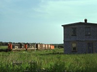 Two CN RSC-13s amble by a typical Up-West house as they near Mileage 77.7, St. Louis, Prince Edward Island on an evening in July 1974. <br> <br> 

At Tignish, Mileage, 84.6, the western end of the Kensington, Sub,  the crew will tie up for the night and start their eastbound 68-mile trip back to Summerside the following morning. <br> <br>

CN 1734 was built by MLW in 1957 and was the last of 35 RSC-13s.  The units began to be retired in the fall of 1975.  CN used their trucks in a Moncton-based program to create "RSC-18s" as replacements on Maritime branchlines.   CN retired 1734 on Monday, December 15, 1975, and its trucks were mated to RS-18 3864, becoming RSC-18 1765 two days later.  It was retired on Thursday, September 30, 1993.  Cape Breton & Central Nova Scotia bought 1765 in 1995 and it served as a parts source for CBNS RS-18 3716.