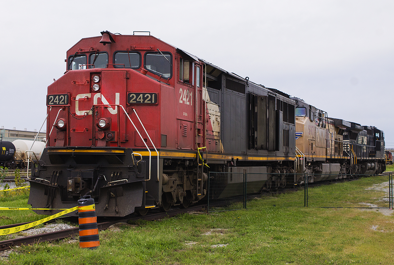 Thanks to Hunter Holmes, who couldn't make the event due to his assignment, my daughter and I had the pleasure to attend CN's Rail Safety Day in September of 2018. This was a good year as just the month before we also were in Sarnia to see VIA's 40th Anniversary train on display downtown at Confederation Park. While my daughter was more enthused by the animals, horse rides and the bouncy castles, I was having a field day living a life long dream. It was so overwhelming being in the midst of CN's operations, standing in the vast Sarnia yard. On a siding, and fenced off to visitors, sits an old 'barn' of sorts in CN 2421 with its doors open. Coupled to it, are a couple of 'FPON' units by way of the Union Pacific and Norfolk Southern railroads.