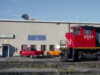 CN M-420 3501 (MLW 5-1973 #M6071-02) poses at the Sydney Shop in the dying days of CN service to Cape Breton in early September 1993. <br> <br>  

In May 1973, the 2501 entered service as the world's first locomotive equipped with a Comfort Cab.  CN worked with both Canadian locomotive builders beginning in the late 1960s to provide increased crash protection for crews as well as electric heating, improved insulation, armchair seats, a refrigerator and hotplate.  After 1973, all newly built road units for CN would include a Comfort Cab.  (See CNR Diesel Locomotives Vol 2, CNRHA 2014, for a detailed history of the Comfort Cab.)  The MR-20a units also featured a freshly designed Zero Weight Transfer (ZWT-2) truck to reduce wheel slip.  Finally, the order for thirty M-420s introduced the diagonal stripes to CN road freight locomotives. <br> <br>  

CN displayed the 2501 for employees at Central Station in Montreal, while 2502 was on display in Sydney in early June 1973.   Beginning in October 1986, CN began a 15-month program in Moncton to lighten the 2500 series units by restricting fuel and sand capacity.  Upon returning to service, CN added 1000 added to their number, reflecting their assignment to secondary duties common to the dwindling number of ageing RS-18s.  The unit was retired on Tuesday, November 25, 1997, and sold in 1998 by CN subsidiary CANAC to the St. Lawrence and Atlantic in Maine.  It operated as their 3501 until the Hudson Bay Railway purchased it on Sunday, April 18, 2004.  The Keewatin Railway running between Flin Flon and Lynn Lake, Manitoba purchased it in 2007 and assigned it the number 2400.  It continues to operate, having borne the number 2402 since 2008. <br> <br>           

In early October 1993, CN began to lease their trackage east of Truro.  Railtex was the initial operator as the Cape Breton & Central Nova Scotia.  Their choice of ex-CN R18s and, particularly, C-630Ms as motive power introduced a golden era between 1993 and 1997 that attracted railfans from around the globe.   In late 2001, Sysco, a provincially owned steel mill closed in Sydney as did nearby coal mines owned by Devco, a federal Crown Corporation.  The closures hugely impacted traffic on the CB&CNS.  By Tuesday, December 30, 2014, Railtex successor Genesee & Wyoming closed operation of the Sydney Sub east of Tupper near Port Hawkesbury on Cape Breton Island's southern shore.  