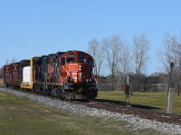 Rolling down the jointed rail of CN's Pelton sub (formerly C&O Sub 1), CN's morning local run out of Van De Water is on the return trip winding it's way through the city. On the approach to where Pelton JCT. and Pelton tower once stood a C&O era call box has stood the test of time here. With Pelton Interlocking being controlled by C&O, NYC trains would then have to call the tower for permission through the junction. When a C&O train and a NYC train would show up at once, the NYC train would typically get precedence as C&O's traffic was mainly locals. Prior to roughly 1989, C&O crews did not have base radios. So the odd time they would roll up on a red signal without any CASO traffic in sight, they would us the callbox to call via codeline to Pelton's tower for permission to cross. Info provided by user: mercer<br><br>Since that time CN has taken out the diamond and tracks leading up to where the tower once stood. After purchasing the Sub 1 from CSX they went ahead and added a wide swooping connector onto the CASO which this train will traverse a few kilometers ahead.<br><br> Also a neat note is the Pere Marquette era cement whistle post.