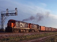 CN C-424s 3230 and 3229 lead a freight through Aldershot on fine spring evening in 1969. Note the block of reefers on the head end, both mechanical and ice cooled!
