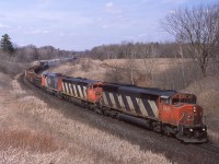 Before the golf course and before the bridge, the curve between mile 30 and 31 Halton Sub was an awesome spot to shoot the afternoon rush. March 31, 2002 sees a trio of "Draper Tapers" dropping downgrade toward Milton. 