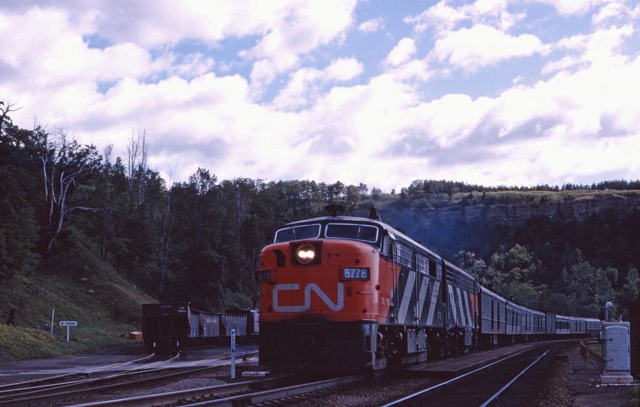 I don't have any records of the train ID; however, a check of the October 25, 1964 public timetable suggests that this is train No. 77 a daily except Sunday schedule between Toronto and London with 14 stops. Like No. 18--which also made its last run on December 31, 1964--this train was a "milk run" express-handling train--note the 7 head end cars and a single coach. Interestingly, the train departed Toronto first but was "scooped" by Toronto-Windsor train No. 29 while making its Hamilton station stop (departing at 9:33 AM). No. 77 did not have a scheduled stop at Dundas; passengers were accommodated on No. 29. Power is an FPA-4/CPA-16-5 combo!