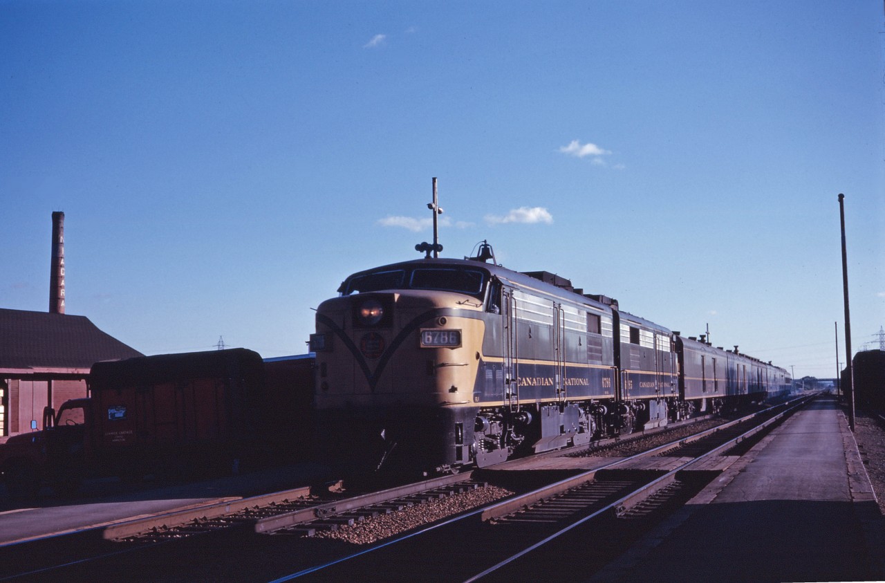 On a fine summer evening in 1962, train No. 18 pauses at Burlington behind FPA4s 6786 and 6785. Largely an express train (with a sole "rider coach" at the tail end), this train originated in London at 4:45 PM daily except Sunday and was scheduled to arrive in Toronto at 8:50 PM then depart four hours later for Montreal's Central Station, finally arriving at 10:40 AM. In prior years, this train originated in Windsor (for example, the April 30, 1961 public timetable shows No. 18 departing Windsor at 12:50 and arriving London at 3:42 PM). In April 1962, CN made changes to service in southwestern Ontario, so perhaps the express traffic from Windsor was moved on No. 106 which was scheduled to depart Windsor at 11:35 AM. A review of public timetables turned up a note stating the last trip of No. 18 from London to Toronto was December 31, 1964; the train was still shown between Toronto and DORVAL in April 1965 timetables and no longer listed a year later.