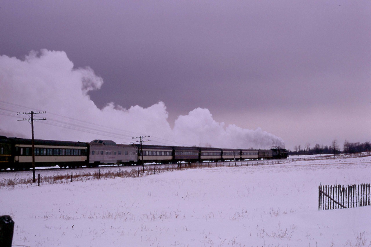 In the waning hours of a cold and blustery Sunday afternoon, the 28th of January 1968, CNR Northern 6218 heads home to Toronto.  Passing Brechin, near Mileage 72 of the Bala Sub, the train has almost completed a circle around Ontario's Lake Simcoe.  The trip, sponsored by the Upper Canada Railway Society, had traversed 98.8 miles of the Newmarket Sub along the west side of the lake to Washago, junction with the Bala Sub.   After that, 88.9 miles down the Bala Sub would bring the excursion train back to Union Station.

The consist featured B&O's Moonlight Dome, which CN leased for Centennial Year and into the early part of 1968.  C&O had ordered the car from Budd for its ill-fated Chessie streamliner in 1946.  Dubbed a Strata-Dome, it featured three drawing rooms, a bedroom and five roomettes.  When delivered in December 1950, it was sold to the B&O and used every other day on the Chicago - Jersey City / Baltimore Shenandoah until October 1963.  It then served as a backup car to mates Starlight Dome and Sunlight Dome on the Capitol Limited.   B&O leased the three cars to the Atlantic Coast Line for use between Richmond and Miami on its Florida Special in 1965-66.  After serving with CN, B&O leased it to the SCL in July 1968 and sold it to them in September 1969.  Again it served on the Florida Special.  

With the advent of Amtrak, the car served until its sale in 1978.  It had a variety of owners until 2014 when Birch Grove LLC purchased the dome and based it in Chicago.
