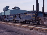 A train from Niagara stops to work at Parkdale Yard in Hamilton. While waiting for delivery of GP38-2s and M420Ws in 1972-73, CN had many C&O GP9s on lease; here we see 6041,6054, and CN SD40 5047.