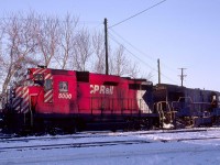 CP Rail 5000 pauses on its way back to Train 1-915 from the Smiths Falls, Ontario shop track in January 1974. <br> <br>

The GP30 was one of just two on CP Rail.  Delivered as 8200 on Saturday, March 30, 1963, with serial A-2006, it was the CPR's first turbocharged unit.  GMDl gave trade-in credit for wreck damaged F9B 1902.  C-424 8300 followed a month later.  GMDL had replaced the two-year-old GP30 model with the GP35 by the time the CPR placed a followup order for a dozen units in June.  MLW received the next order for 32 C-424s in September 1964.  CPR renumbered the 8200 to 5000 on Monday, April 12, 1965.  It is now displayed in Edmonton, Alberta. <br> <br>     

The CPR was chronically short of motive power, especially during the busy winter season from 1963 through 1975.  In the following decades, CP Rail often experienced motive power shortages.  Leased P&LE U28B 2810 (GE 1-1966 #35866) is today's solution.  This unit travelled far and wide from western Pennsylvania during its career before settling on TTI, the Transkentucky Transportation Railroad based in Paris, Kentucky.   It was one of seven former P&LE U28s that helped TTI haul coal fifty miles to an Ohio River transload at Maysville in northeastern Kentucky.  Renumbered to 249 it was scrapped on the TTI.  The TTI started in 1979 and became a CSX subsidiary in 1981.  Since 2017 it has been reduced to transloading and car storage in Paris. 