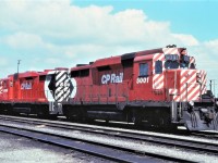 Both of Canadian Pacific's GP30s, 5000 and 5001, wait the call to duty at the west end of the engine facility at Agincourt Yard.  The units display different versions of the action red paint scheme.