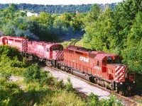 A northbound CP train waits to continue it's journey on the Hamilton Subdivision as it pauses near the Dundurn Street bridge in Hamilton with 5751, 4211 and 5734. Luckily, the early morning sun is high enough that most of the shadows have retreated away from the power. This location has changed considerably over the years including the installation of a second track a couple years after this photo was taken. 