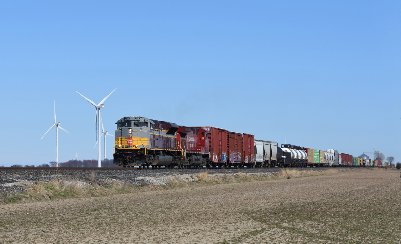 Over the past few days CP 235 has been good to us in Southern Ontario as well to the Detroit locals. Here we see 7018 wearing it's beautiful maroon and grey paint scheme, rolling past some of the many wind turbines that dot Essex county.