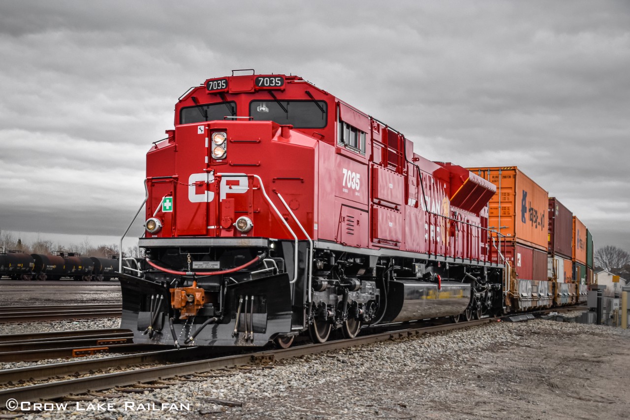 Canadian Pacific's newest SD70ACu at the time provides extra horsepower at the tail of CP 142 past Smiths Falls.