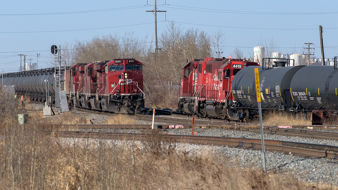 After a morning of CN Clover Bar, I made a stop in at the East Edmonton diamond to see if CP was making a move. As luck would have it, an oil train of empties for Kinder Morgan was approaching with the IOL crew also doing some work. The oil cans were headed up with 4 units, the 8111, 8778, 8784 and 8029. The 8776 was on the tailend. The 4507 and 4419 sat parked for the moment as the IOL crew, on the far left, stood and inspected. The 8111 is just a few car lengths from the diamond, the pink rail joints being on CN's Camrose Sub. The curving track in the immediate foreground is CP's lead into Kinder Morgan.