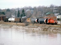 CP SW1200RS 8160 handles a short train on the old Lake Erie & Northern line (now the CP Simcoe Sub), as viewed across the Grand River in Brantford. Note the old LE&N car barn in the background. Units 8160, 8161 and 8162 were regulars on the old "CP Electric Lines" (GRR and LE&N) for decades.<br><br>When CP <a href=https://otc-cta.gc.ca/eng/ruling/383-r-1989><b>abandoned the line in the late 80's</b></a>, CN acquired small portions of TH&B and LE&N trackage in Brantford and operated them as part of the Burford Spur. This section survived to service the old SC Johnson & Son plant until the early 2010's.