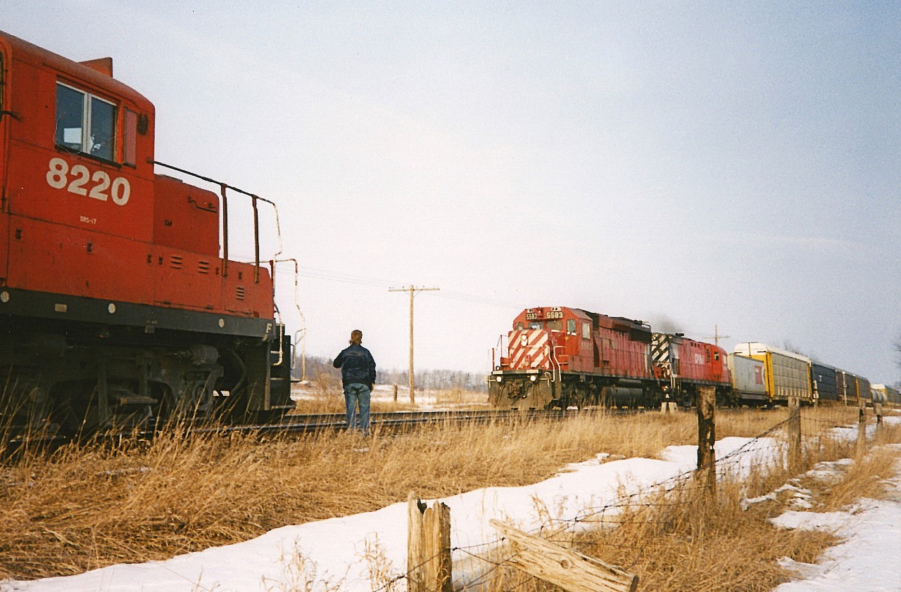 Back in the 1990's Wolverton was always a great place to spend some time as it was near the middle of the OCS section of the Galt Subdivision, it was usually a popular spot for train meets as well as being one of the longer sidings on the line. It was literally just a long siding in the middle of farm fields as the yard was still a decade away from being built. Plus, Trussler Road was less busy with traffic compared to now, so one could have a fairly relaxing wait between trains. Here, CP 8220 and 5403 are on an eastbound in  the siding at the east switch meeting a fast moving westbound with 5583 and 4240 during a Sunday afternoon.
