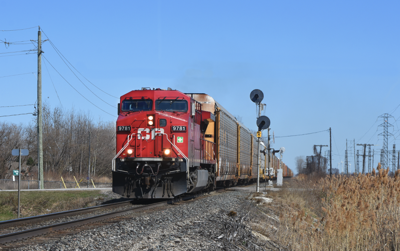 With a quick heads up from a friend East of this location, I packed up my cameras and ladder and made my way out to Belle River. Due to the steep banks right off the sides of the track along the Windsor sub its quite difficult to get a shot where you're not looking up. Here we see a ridiculously early 147 rolling past the signals guarding the West switch of Belle River siding.