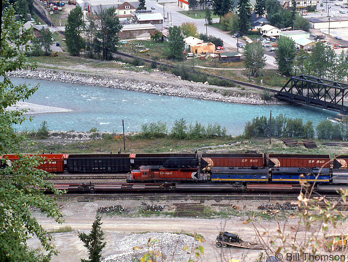 VIA train #2 "The Canadian" is shown from high above at Golden BC, along the Kicking Horse River (in the background, near 11 Avenue S and 9th Street S). A CP SD40-2 heads up today's train, likely replacement power for a failed VIA F-unit, followed by two VIA F9B's. Replacement CP power often had to rescue The Canadian in the 80's due to VIA's aging fleet inherited from CN & CP. New VIA power would start to arrive in 1986 in the form of new F40PH units from GMD.