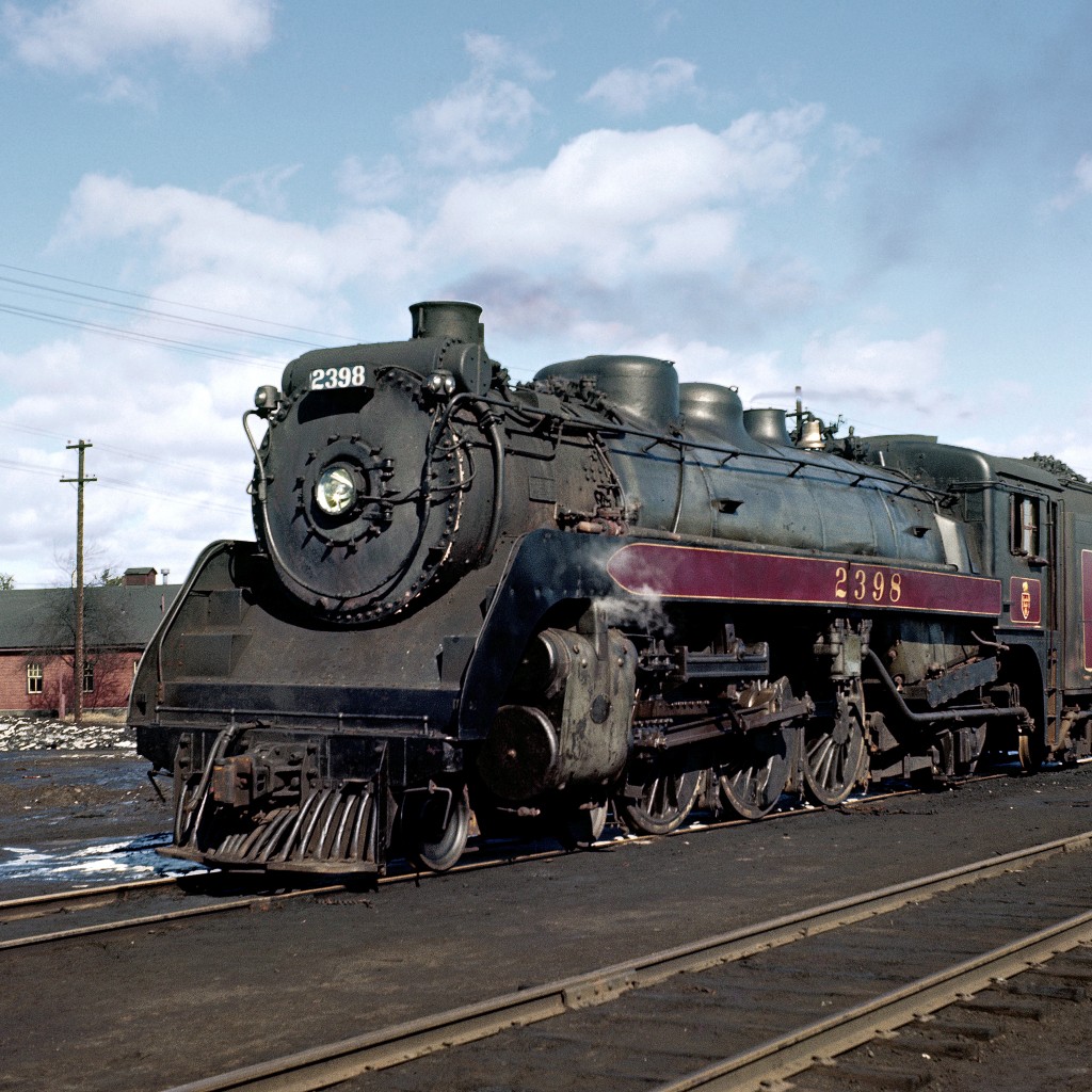 "These 'Twenty Four Hundreds' (actually, 2351-2472) were very capable locomotives built with one piece cast bed and multiple throttle. They were as different as day and night compared to earlier G3's 2300- 2350. They were considered the best steam locomotive on the CPR, true dual service freight or passenger engines with 75 inch diameter drivers. They were the only class painted in either freight black and/or passenger tuscan red. They had a sharp "shotgun" exhaust and rapid acceleration with no tendency to slip unlike the Royal Hudsons which could be slippery starting heavy freight tonnage."


Narrative from Trainweb.org/oldtimetrains.


Image circa 1959.


Original digital scanning by DigMyPic in Arizona.  Additional digital editing and enhancement courtesy of Mr. Raymond Farand.