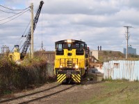 After lifting a boxcar from a nearby warehouse, ETR 107 along with 105 shove a cut of gondolas into K-Scrap off of Russell St. on Windsor's west end. One of several cranes located at the scrap yard is seen at left, and a new spur can be seen under construction on the right heading into Sterling Fuels, which receives asphalt by rail on occasion.  