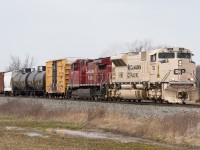 CP 246 blasts through Grassie Ontario with a whopping 5 cars.  In the lead is CP 7021 the Military tribute locomotive that wears the sand colours that Canadian and American militaries apply to their vehicles that are deployed in Arid climates.