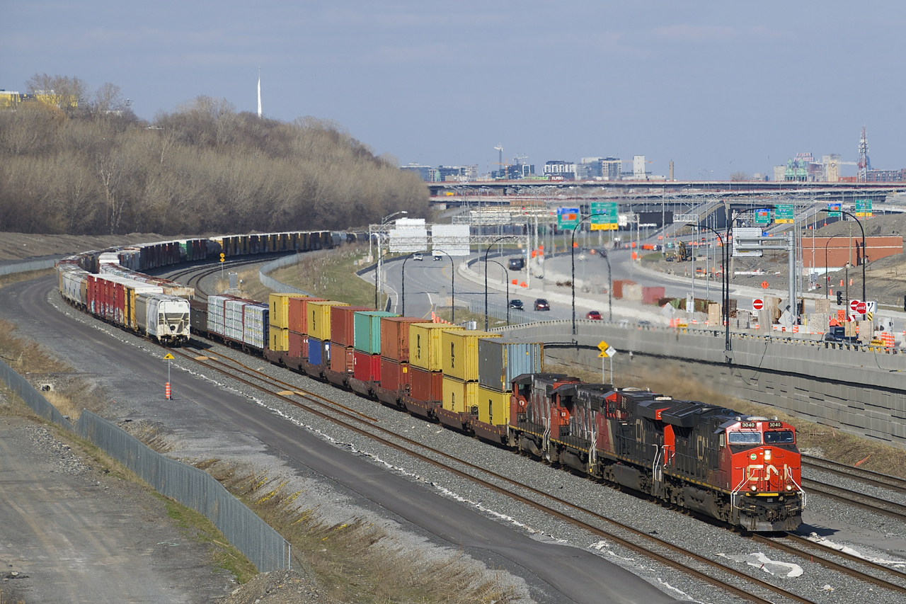 CN 401 with CN 3040, CN 3811, CN 4760 and CN 4769 is passing a long string of parked cars that are on Track 29 of CN's Montreal Sub as it approaches Turcot Ouest.