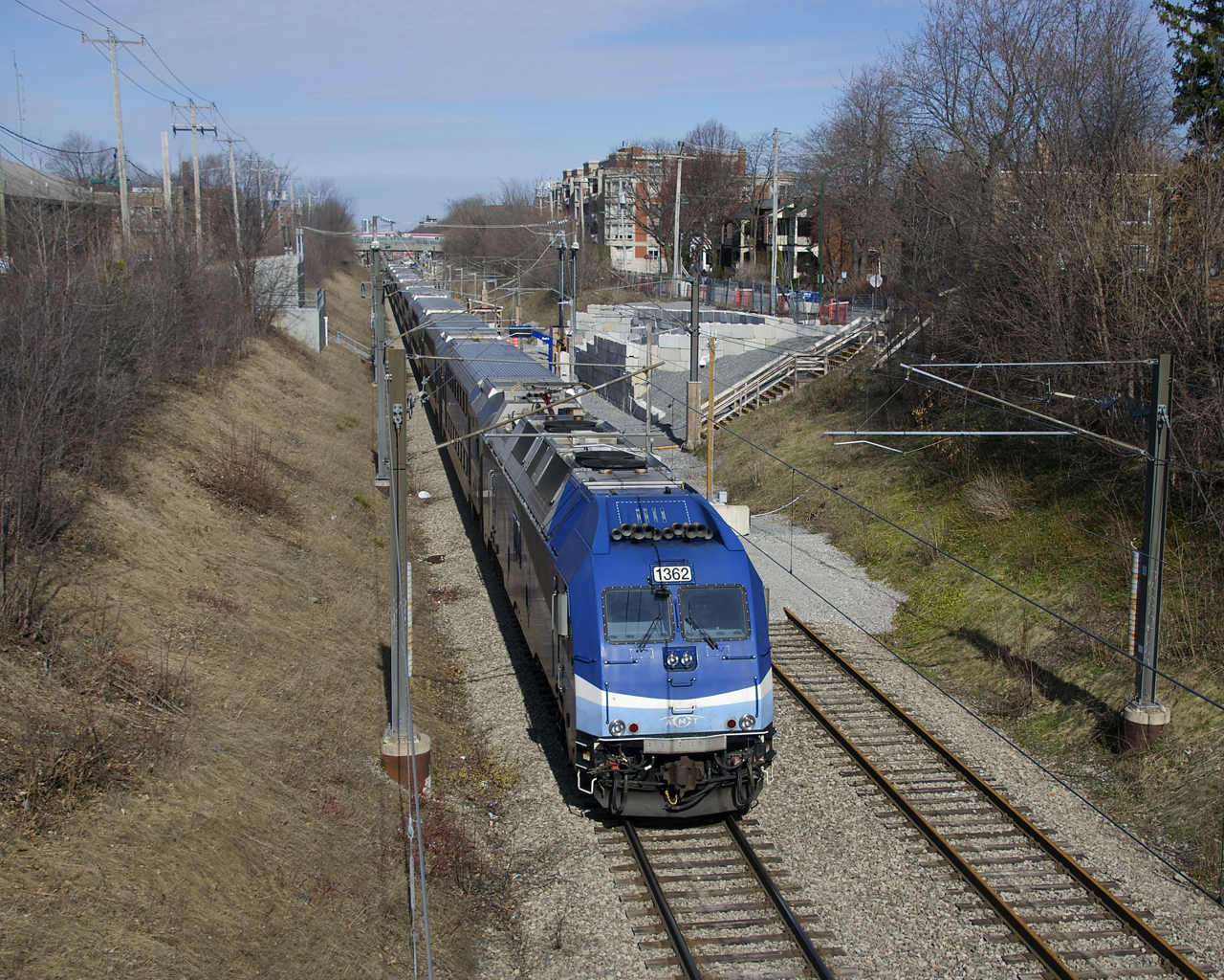 AMT 1362 is on the rear of a deadhead move that is passing through the combined stations of Canora and Mont-Royal. This line was double-tracked until the summer of 2018 when work started on the REM light rail project. This work necessitated the closure of the existing Canora and Mont-Royal stations, with a new one located roughly halfway between the two stations. The track at right is not in use and has been paved over both north and south of there. This part of the Deux-Montagnes line was supposed to be closed for a number of years starting March 29th, but all work on the REM project has stopped for the time being and trains are still running here.