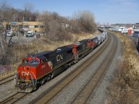CN 527 with CN 2166 & CN 2201 is advancing west before backing up and setting off a cut of CP grain cars on Track 29.